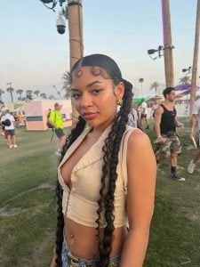 A woman at a festival with a slicked back hairstyle