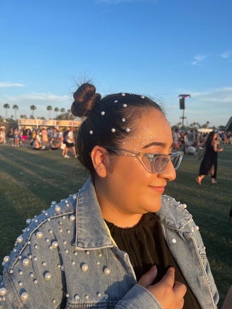 A woman at a festival wearing hair gems