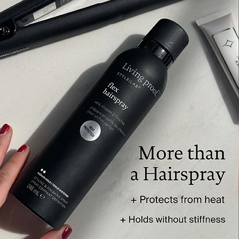 Image 1 - A black Living Proof Flex Hairspray can is shown with a hair straightener and other products, with overlaid text: Living proof. STYLE|LAB® flex hairspray sets, shapes & finishes prépare et coiffe les cheveux pour un fini parfait HEAT PROTECTION MEDIUM HOLD | TENUE MOYENNE STYLING & FINISHING SPRAY SPRAY COIFFANT DEFINITION 246 mL e More than a Hairspray + Protects from heat + Holds without stiffness.
Image 2 - Image shows a womans hair styled straight on the left labeled Before and curled on the right labeled After, with text How to hold your curls with Flex Hairspray above.
Image 3 - An image showing a black Living Proof hairspray bottle with text around it listing benefits including Heat protection Flexible touchable hold and Set style plus finish without stiffness with text on the bottle reading Living proof STYLE|LAB flex hairspray sets shapes & finishes prépare et coiffe les cheveux pour un fini parfait HEAT PROTECTION MEDIUM HOLD TENUE MOYENNE STYLING & FINISHING SPRAY SPRAY COIFFANT DEFINITION 246 mL e 212 g 7.5 OZ US.
Image 4 - A hand holds a black spray bottle, spraying mist, with text overlays detailing product technology and benefits including Conditioning Emollient, Adds lubricity, brushability + shine, Flexible Web Technology, A blend offering multi-styling benefits + medium hold on damp or dry hair, Vitamin B5, Adds softness + conditioning, and Living pro STYLE|LAB®.
Image 5 - Two close-up images show broken pieces of traditional hairspray resin on the left and a flexible film of Living Proof hairspray technology on the right, with text Flex Hairspray keeps its flexible hold even when you touch it Traditional hairspray resins break easily Living Proof Flexible Web Technology is flexible.
Image 6 - A womans profile with long brown hair and highlights is shown, with a hand touching her hair, and text that reads For pro-level results at home.
Image 7 - An image shows three black bottles of Living proof flex hairspray under the title A Stylists Favourite with bubbles listing benefits HEAT PROTECTION WORKABLE & BRUSHABLE FINISH LUXURIOUS SCENT and bottle text Living proof STYLE|LAB flex hairspray sets, shapes & finishes.