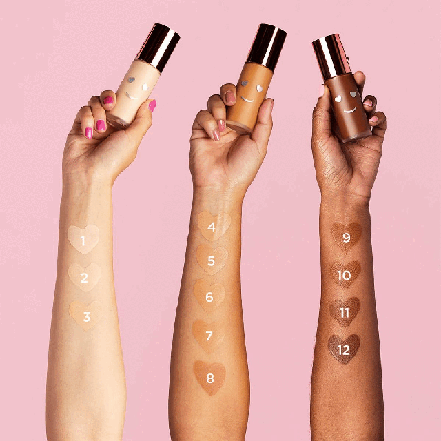 Model hand swatch shades. Models wearing shades. Model applying product to skin.