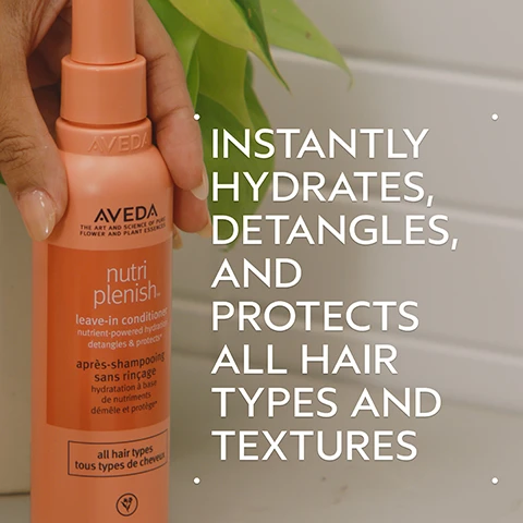 Image 2 - A hand holds an orange Aveda Nutriplenish Leave-In Conditioner bottle with a blurred green plant in the background. The bottle features text including AVEDA THE ART AND SCIENCE OF PURE FLOWER AND PLANT ESSENCES nutri plenish leave-in conditioner nutrient-powered hydration detangles & protects après-shampooing sans rinçage hydratation à base de nutriments démêle et protège all hair types tous types de cheveux. Large white text on the right side of the image states INSTANTLY HYDRATES, DETANGLES, AND PROTECTS ALL HAIR TYPES AND TEXTURES. Image 3 - A dark green background features a large white circle filled with bright red pomegranate arils that appear wet and shiny, with light blue and white hues creating a fresh backdrop. The text reads: POMEGRANATE OIL HELPS PROVIDE NUTRIENT-POWERED HYDRATION. Image 4 - A before-and-after image shows a woman with dark curly hair; on the left, her hair is voluminous and slightly frizzy, labeled BEFORE and Unwashed Hair, while on the right, her hair appears more defined and hydrated, labeled AFTER, with accompanying text: Results with Nutriplenish ™ Shampoo and Conditioner: Deep Moisture, Nutriplenish Leave-In Conditioner, Curl Gelee, Replenishing Overnight Serum and Wooden Paddle Brush. Blow dried with diffuser attachment. Image 5 - Three glossy white spherical drops, one large and two smaller, are arranged on a white background with soft shadows. Image 6 - Three circular images illustrate a hair care routine: a person washing hair, hands dispensing white conditioner from a tube, and hands dispensing clear gel from a tube, alongside the text HOW TO USE, 01 CLEANSE Nutriplenish™ Shampoo: Deep Moisture, 02 CONDITION Nutriplenish™ Conditioner: Deep Moisture & Leave-In Conditioner, and 03 STYLE Nutriplenish™ Curl Gelee & Replenishing Overnight Serum. Image 7 - Dark green tropical leaves form the background for three white certification logos: the first is a circle with a large V and the text 100% VEGAN, the second is the Certified B Corporation logo, and the third is the Cruelty Free International leaping bunny logo.