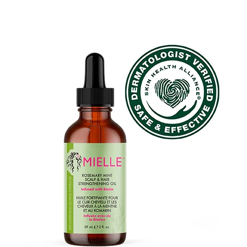 Image 4 - An amber bottle with a dropper contains a clear hair and scalp strengthening oil, set against a light green background with text that reads features more than 30 essential oils and extracts, infused with biotin, and use for daily hair care or scalp treatments.
Image 5 - An amber bottle of Mielle Rosemary Mint Scalp & Hair Strengthening Oil with a dropper is positioned on a light gray podium, against a pink background, with instructions on how to use it: Scalp Treatment, Daily Use, and Split End Care.