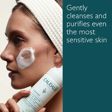 Image 1 - A woman with a white headband is applying foaming cleanser to her cheek while holding a bottle labeled Caudalie Vinoclean, accompanied by text that reads gently cleanses and purifies even the most sensitive skin.
Image 2 - Image of a white bottle of Caudalie Vinoclean Instant Foaming Cleanser surrounded by green grapes, leaves, and small flowers, with text indicating the benefits of green grape for hydration, sage for purification, and chamomile for soothing skin. The visible text includes CAUDALIE PARIS, Vinoclean, Mousse Nettoyante Fleur de Vigne, Instant Foaming Cleanser, 150ml - 5 FL. OZ. and recycling information.
Image 3 - Image features two skincare products from Caudalie: on the left, a bottle of Makeup Removing Oil with a green background, and on the right, a bottle of Instant Foaming Cleanser with a light green background; visible text includes product names, descriptions of their textures and benefits, and information about their formulations.
Image 4 - Image of a bottle of Caudalie Vinoclean Instant Foaming Cleanser surrounded by greenery, with instructions on recycling: 1. Recycle the bottle in the recycling bin, 2. Recycle the pump with Terracycle.
Image 5 - Image shows five bottles of skincare products from the brand Caudalie, labeled as Micellar Water, Make-up Removing Oil, Instant Foaming Cleanser, Cleansing Milk, and Moisturizing Toner, with their respective product descriptions visible on the labels.