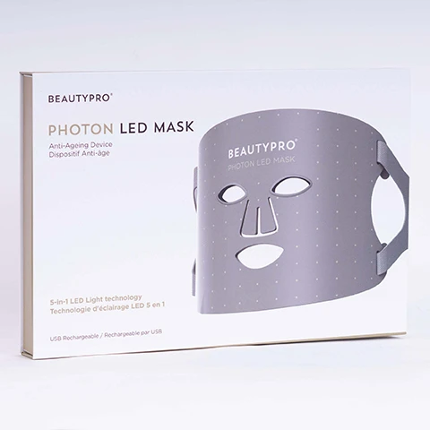 Image 1 - A gray LED facial mask with cut-out eye and mouth areas is shown on a white backdrop, accompanied by text that reads BEAUTYPRO PHOTON LED MASK Anti-Ageing Device 5-in-1 LED Light technology USB Rechargeable.
Image 2 - A person is wearing a gray LED face mask with various illuminated colors, labeled for different modes: mode 1 is red for anti-ageing, mode 2 is blue for targeting acne, mode 3 is yellow for brightening, mode 4 is infrared for pore refinement, and mode 5 is purple for anti-ageing/acne. The words BEAUTYPRO are visible on the mask.
Image 3 - A hand holding a skincare device with a digital screen, accompanied by text that reads targets acne and blemishes for clear skin, anti-aging benefits for youthful looking skin, brightens and smoothes the complexion, and promotes cell renewal and collagen production.
Image 4 - Image shows a gray photon LED mask with cut-out openings for the eyes and mouth, displayed alongside five gold stars indicating a rating, and text that reads: Photon LED Mask Ive had and enjoyed LED therapy in salons before but with the cost of everything going up, its amazing that I can now enjoy the benefits and experience in the comfort of my own home and at a fraction of the price.