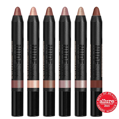 Image 1, best of beauty award winner - allure 2023. image 2, model shots of magnetic luminous eye in the shades - rustic grotto, nudity, burnish, pink seychelles, praia, maroon'd. image 3, swatches of nudity, pink seychelles, rustic grotto, burnish, praia and maroon'd on three different skin tones. image 4, swatches of nudity, pink seychelles, rustic grotto, burnish, praia and maroon'd. image 5, waterproof, smudge proof, easy to blend, quick drying, long wearing (11 hours), 3 in 1 multitasking cream formula = eyeshadow, eyeliner and eye primer. on the go stick application. clean, vegan and cruelty free. every kit comes with a recyclable tin and mirror. image 6, every palette comes with a tin. join a small movement and make a big difference. nudestix uses reusable tins for an important reason. we do not believe in single use watse. we encourage reusable and recyclable materials with environmentally friendly packaging. reuse your tin = organise your products and touch up makeup on the go. other things to store in your tin - jewellery, headsets etc. recycle with us = tinplate is the most infinitely recyclable material in the world that can be recycled into useful industrial products. recycle based on your local recycling centre. sharpener included.