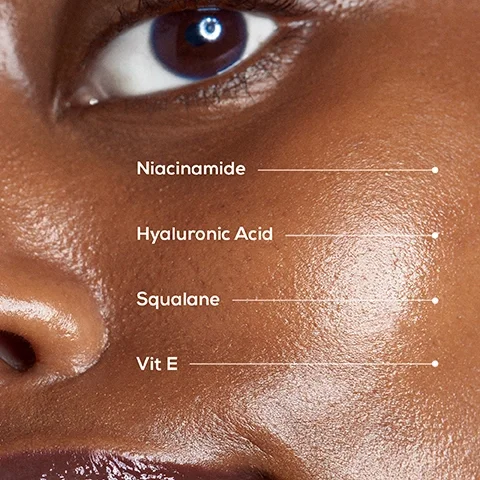 Image 1 - Close-up of a person’s cheek and eye showcasing smooth, glowing skin with visible text listing skin care ingredients: Niacinamide, Hyaluronic Acid, Squalane, Vit E.
