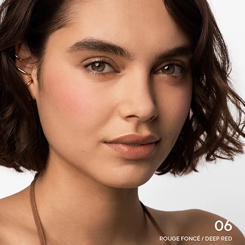 Image 1 - A close-up portrait of a woman with curly brown hair and natural makeup, featuring a subtle blush and nude lips, with visible text that reads 06 ROUGE FONCÉ / DEEP RED.
Image 2 - A close-up portrait of a woman with medium brown skin and natural makeup, featuring gold hoop earrings, with visible text reading 06 ROUGE FONCÉ / DEEP RED.
Image 3 - Three circular makeup compacts are displayed, each with a different shade of bronzer and blush by Guerlain, featuring the text TERRACOTTA GUERLAIN on the compacts and UP TO 96% NATURAL ORIGIN in the bottom corner.