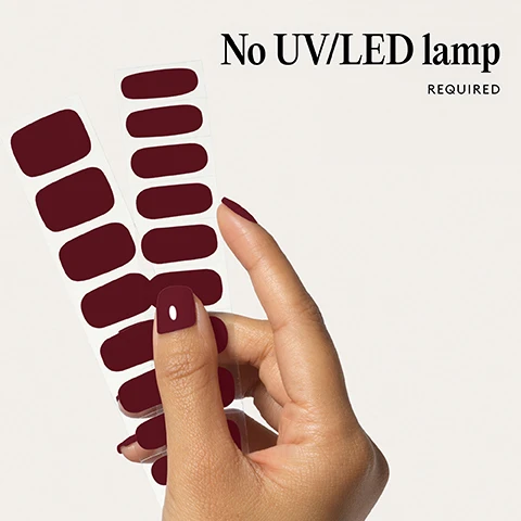 Image 1 - Hand holds sheets of deep red nail stickers, with the text No UV/LED lamp REQUIRED. Image 2 - Two dark red gel nail tips, one large and one small, are shown on a light background with the text 100% real salon-quality gel. Image 3 - A close-up of a persons mouth with dark red lipstick and a finger with matching nail polish touching the lip, with icons and text indicating Cruelty-free, Vegan, HEMA-free. Image 4 - A hand with four fingernails painted dark red next to text that says 1 minute removal NO DAMAGE. Image 5 - A diagram showing the steps for applying nail wraps with illustrations, titled Step by step, with steps 1 PREP, 2 STICK & WRAP, 3 TRIM & FILE, and 4 REMOVE listed alongside text descriptions. Image 6 - A sheet with red nail polish strips next to a list of product features: Easiest and gentlest mani in the world Lasts up to 14 days Fast & gentle 1-min removal Fully-cured - No LED Lamp required Comes in 10 sizes Long-lasting shine and chip-resistant Quick and easy application Hema-free, vegan, and cruelty-free Pre-cut and ready to go!