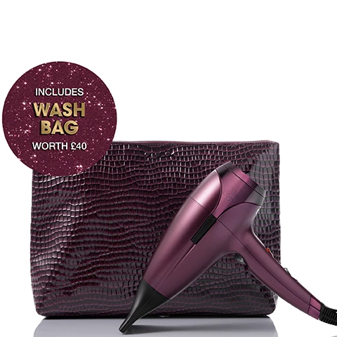 Image 1 - A dark purple, crocodile-embossed wash bag stands behind a matching purple ghd hair dryer, angled downwards, with a glittery badge stating INCLUDES WASH BAG WORTH £40. Image 2 - A dark red GHD Helios hair dryer is showcased on a sparkling gold background, surrounded by dark red crocodile-textured gift boxes, one of which has a ribbon that reads GOOD HAIR DAY, and large white text at the top of the image says GHD HELIOS GIFT SET. Image 3 - A purple ghd Helios hair dryer and a matching crocodile-embossed wash bag are shown on a white background, with text below reading WHATS INSIDE: Limited Edition ghd Helios Hair Dryer & Wash Bag. Image 4 - A woman with voluminous curly hair, red lipstick, and an off-shoulder black top holds a metallic purple hairdryer with a diffuser to her head, surrounded by purple crocodile-textured bags on a glittery gold surface against a red GHD logo background, featuring the prominent text 30% MORE SHINE and the small disclaimer *DIFFUSER ATTACHMENT SOLD SEPERATELY. Image 5 - A smiling woman with curly brown hair holds a plum-colored ghd hairdryer with a diffuser attachment against a pink background with ghd logos, with the text PERFECT FOR SLEEKER, SMOOTHER, SHINER BLOWDRIES and *DIFFUSER ATTACHMENT SOLD SEPERATELY. Image 6 - A dark red ghd hair dryer with a black nozzle and handle is angled on a sparkling golden glitter background, with the text New GHD Limited Edition Cherry Chic Collection overlayed in white.