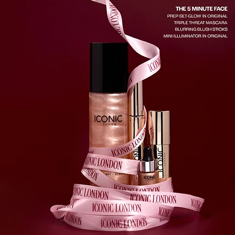 Image 2 - A set of Iconic London beauty products including a large bottle of shimmering liquid, two gold tubes, and a small dropper bottle, all wrapped with a pink ribbon featuring the brand name, against a deep red background, with white text in the top right corner stating: THE 5 MINUTE FACE, PREP-SET-GLOW IN ORIGINAL, TRIPLE THREAT MASCARA, BLURRING BLUSH STICKS, MINI ILLUMINATOR IN ORIGINAL. Image 3 - A woman with long dark hair, winged eyeliner, and glossy lips holds a gold mascara tube labeled ICONIC LONDON, wearing a black blazer and gold earrings against a red curtain background, with the text THE 5 MINUTE FACE TRIPLE THREAT MASCARA in the top right. Image 4 - Four Iconic London beauty products are displayed on a white background: a small golden dropper bottle, a gold stick with a red tip, an open gold mascara tube with its wand, and a tall shimmering peach spray bottle, accompanied by text reading The 5 Mintue Face, Triple Threat Mascara Our Best Selling Trending Mascara, Mini Illuminator Our Must-Have Highlighter With Over 1900 5 Star Reviews, and Prep Set Glow Our Best Selling Viral Prep And Setting Mist, with additional text on the products stating Iconic London Illuminator Illuminateur Original, Iconic London, Iconic London and Iconic London Prep - Set - Glow. Image 5 - The image displays four product review cards on a red velvet background, each with a five-star rating; the first card reads TRIPLE THREAT MASCARA My favourite mascara, no clumping and makes my lashes look long, easy to remove. Like it so much brought as gifts ! Claire C; the second card reads BLURRING BLUSH STICK This beauty of a blush glides on, smudges in well and can be built up if a darker blush is needed. It lasts all day long and is my new favourite blush - Jayne; the third card reads ILLUMINATOR I use this with matte foundation. Gives me a bit of illumination. Ive received compliments on how healthy my skin looks. - Stacey; and the fourth card reads PREP - SET - GLOW I have been buying this product for 5 years now. Not only does it smell lovely but it works so well and really makes my make up look good afterwards. Would definitely recommend it! - Sam. Image 6 - A grid of four cosmetic product images displays shimmering gold liquid drops in the top left, black mascara strokes in the top right, shimmery peach liquid makeup in the bottom left, and a textured pink cream blush swatch in the bottom right, accompanied by text reading ILLUMINATOR SHADE ORGINAL, TRIPLE THREAT MASCARA VOLUMISES LENGTHS LIFTS, PREP-SET-GLOW CUCUMBER EXTRACT CHAMOMILE MICA, and BLURRING BLUSH STICK SHADE COSMO BLOSSOM.