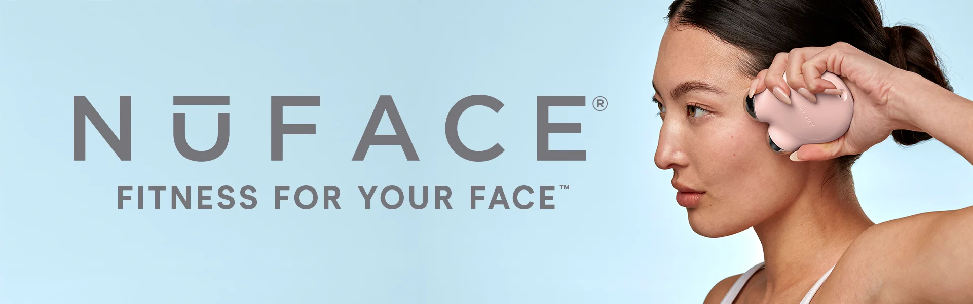 NuFACE Mini Facial Toning Device being used by a model to sculpt cheekbones